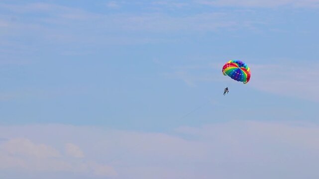 Patong Beach Phuket with turquoise blue water and parasailing Thailand.