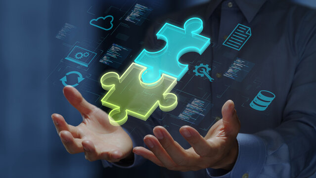 Low-code or no-code development platform concept. Solutions for creating software without coding. Business person holding holographic jigsaw puzzles.