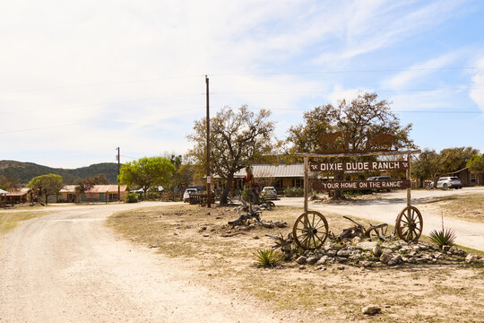 Dixie Dude Ranch, Bandera Texas with the entrance sign and building in the background.