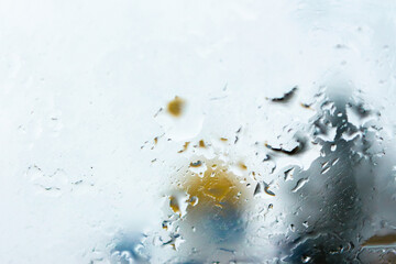 abstract background raindrops on glass. background of blurred urban landscape on a rainy day. wet window with bokeh effect