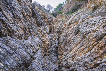 Sedimentary rocks along path from Oldt Town to Mogren Beach in Budva, Montenegro