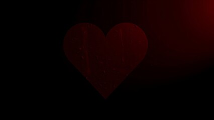 A striking red heart shape illuminated against a dark textured background, evoking deep emotional resonance.