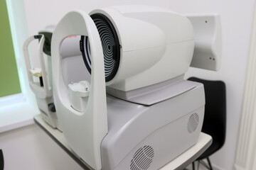 Ophthalmic diagnostic devices: non-contact tonometer and corneal topographer side by side. Used for measuring eye pressure and mapping corneal shape in eye care clinics.