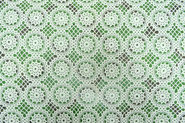 White floral fabric crocheted from cotton threads, textured background