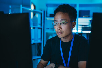 Software engineer developer focused on programming language, coding, and software development in dark office, working on modern IT projects.