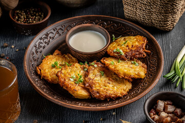Rustic potato pancakes with sour cream and traditional sides