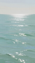 Obraz premium Pastel mint sea with gentle ripples, horizon line fading into a soft sky, subtle reflections