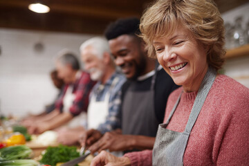Diverse group joyfully prepares food together, symbolizing community, health, and shared experiences. Ideal for illustrating teamwork, wellbeing, and social connection.