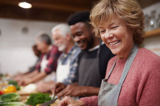 Diverse group joyfully prepares food together, symbolizing community, health, and shared experiences. Ideal for illustrating teamwork, wellbeing, and social connection.