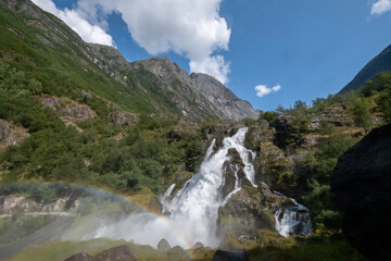 Rainbow on waterfall Kleivafossen fed by Briksdal Glacier. Norway