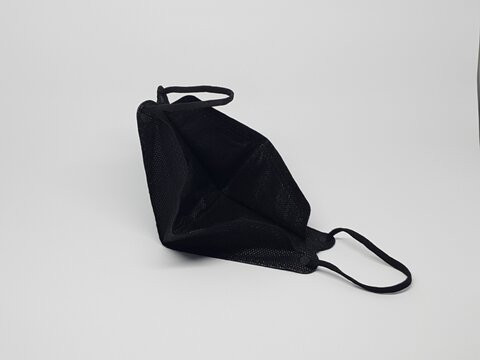 Black reusable cloth face mask isolated on white background, protection against dust and germs