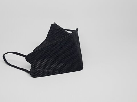 Black reusable cloth face mask isolated on white background, protection against dust and germs