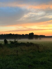 fantastic colorful sky after the sunset, fog at the field, countryside fantastic purple evening