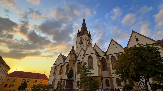 Sunset view of Lutheran Cathedral in Sibiu. The Evangelical Cathedral in Sibiu, Romania, seen at sunset with dramatic clouds in the background.