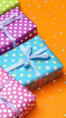 Fototapeta premium Assorted polka dot gift boxes tied with ribbon on an orange background with confetti