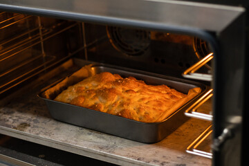Freshly baked focaccia stands in the oven.
