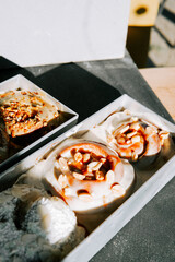 Delicious cinnamon rolls topped with nuts and caramel in a rustic setting