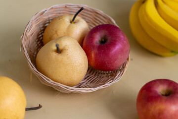 Fresh pears and apples arranged in a basket