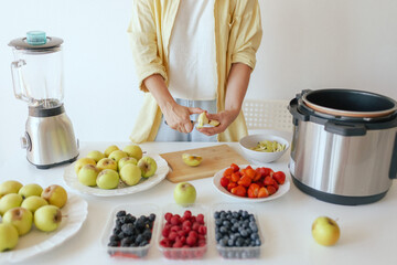 Healthy senior woman in her kitchen. Mature woman serving herself wholesome vegan food at home....