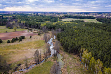 Drone aerial photo of a river arm of Liwiec among fields in Mazowsze region of Poland