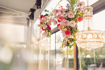 Stunning floral decorations bring elegance to a bright afternoon event in a beautiful indoor space