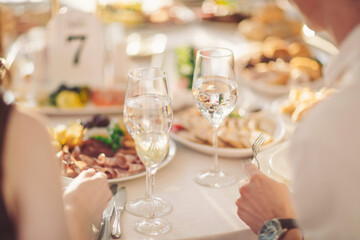 Celebration of flavors and friendship at a sunny banquet table filled with delicious dishes and sparkling water in the afternoon light