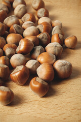 Discovering the beauty of hazelnuts scattered on a wooden surface