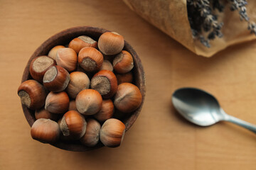 Gathering fresh hazelnuts in a rustic wooden bowl with lavender