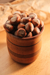Discovering the warmth of rustic kitchen with natural hazelnuts in a wooden bowl