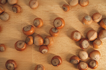 Hazelnuts scattered on a wooden surface showcasing their natural beauty