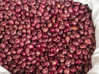 Heap of red speckled beans, organic legumes in bulk for cooking and healthy nutrition
