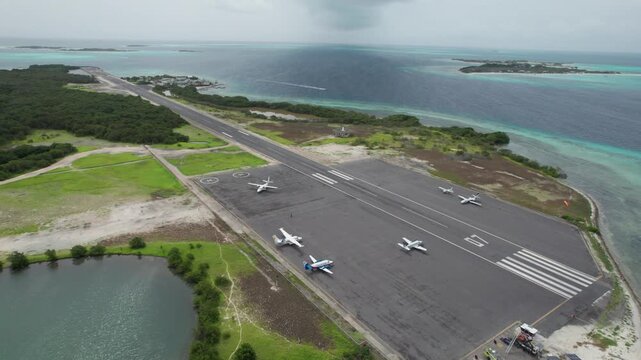 Aerial view of Los Roques airport, planes on runway, serene atmosphere