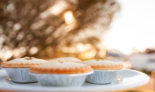 Four fruit mince pies on plate for backyard Christmas party treat