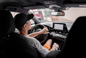 A young guy driving a car.