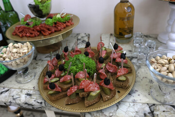 Pieces of bacon and smoked meat on a buffet table.