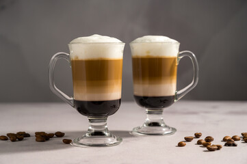 Layered coffee latte drinks. Hot coffee drinks in glass mugs