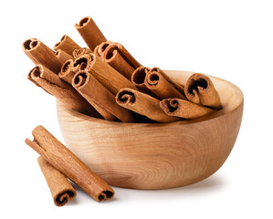 Cinnamon sticks in a wooden plate on a white background. Isolated