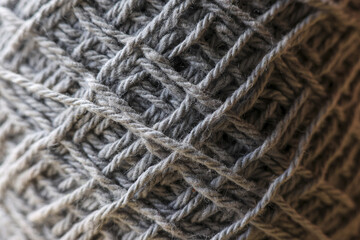 Cozy macro view of gray yarn ball creating detailed background. This wool thread texture feels warm and comforting, perfect for craft or knitting project