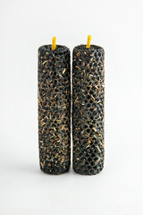 Unique black candles with textured surface and yellow wicks for home decor or rituals