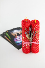 Candles with herbs and tarot cards create a calming atmosphere for spiritual practice