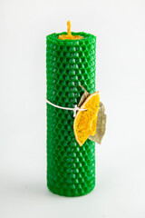 Natural wax candles with bay leaf and dried orange for rituals and space cleansing