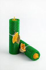 Natural wax candles with bay leaf and dried orange for rituals and space cleansing