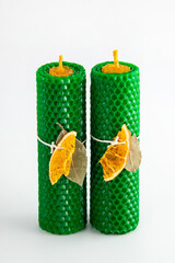 Natural wax candles with bay leaf and dried orange for rituals and space cleansing
