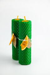 Natural wax candles with bay leaf and dried orange for rituals and space cleansing