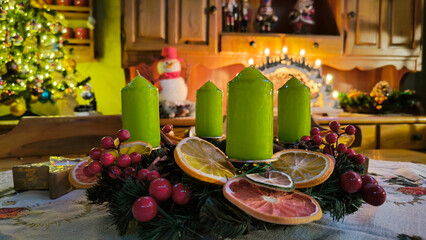 advent wreath decorated with candles, candy canes, dried oranges and pine cones