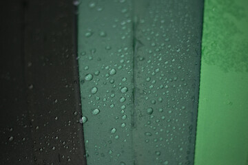 Water droplets create refreshing texture on dark green surface. An abstract pattern, like natural...