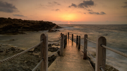 Fototapeta premium Cyprus Mediterranean Coastline with Turquoise Sea, Sandy Beach, and Clear Blue Sky