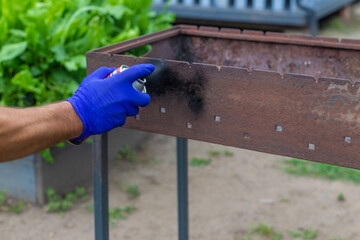 Paint the barbecue with fire-resistant paint. Selective focus.