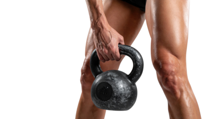 A muscular individual holds a heavy kettlebell, showcasing strength and athleticism in a dynamic pose.