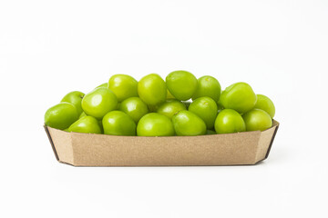 Fresh green grapes in a craft cardboard box on a white background. Isolated